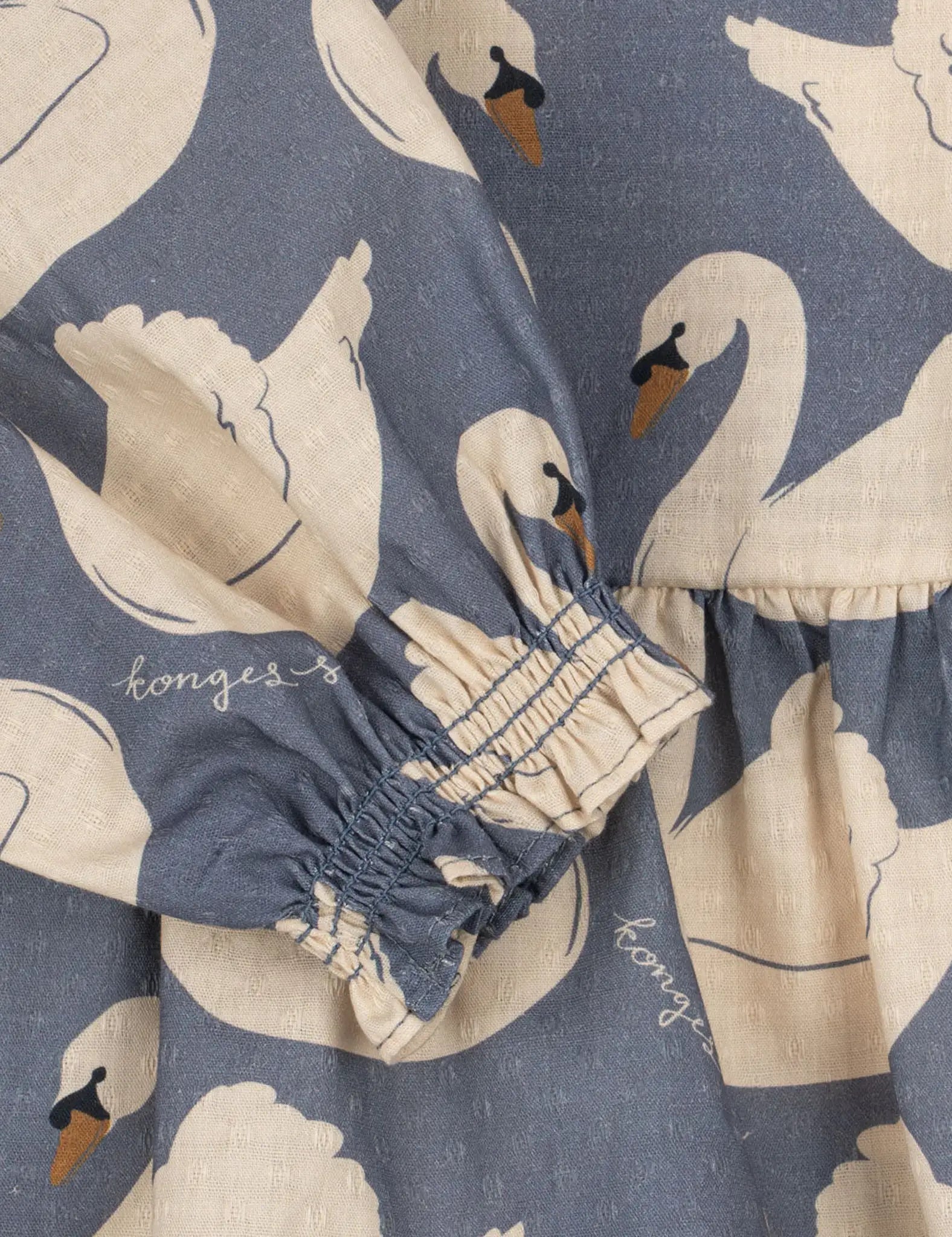 Blusa azul-marinho com cisnes, punhos elásticos franzidos e barra larga. Konges Sløjd